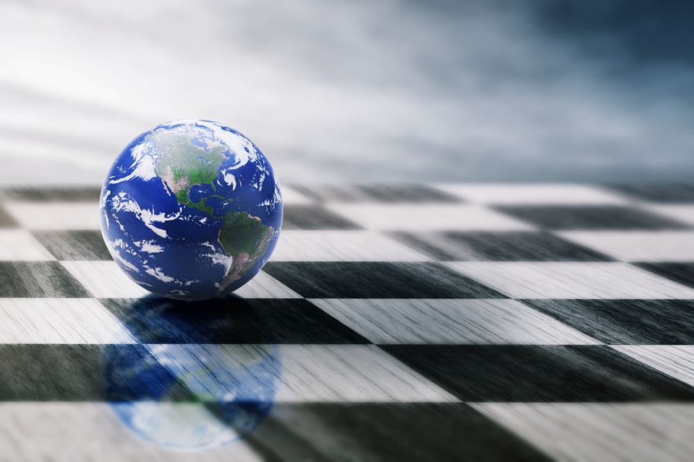 World on a Chessboard Isolated on Blue Sky Background